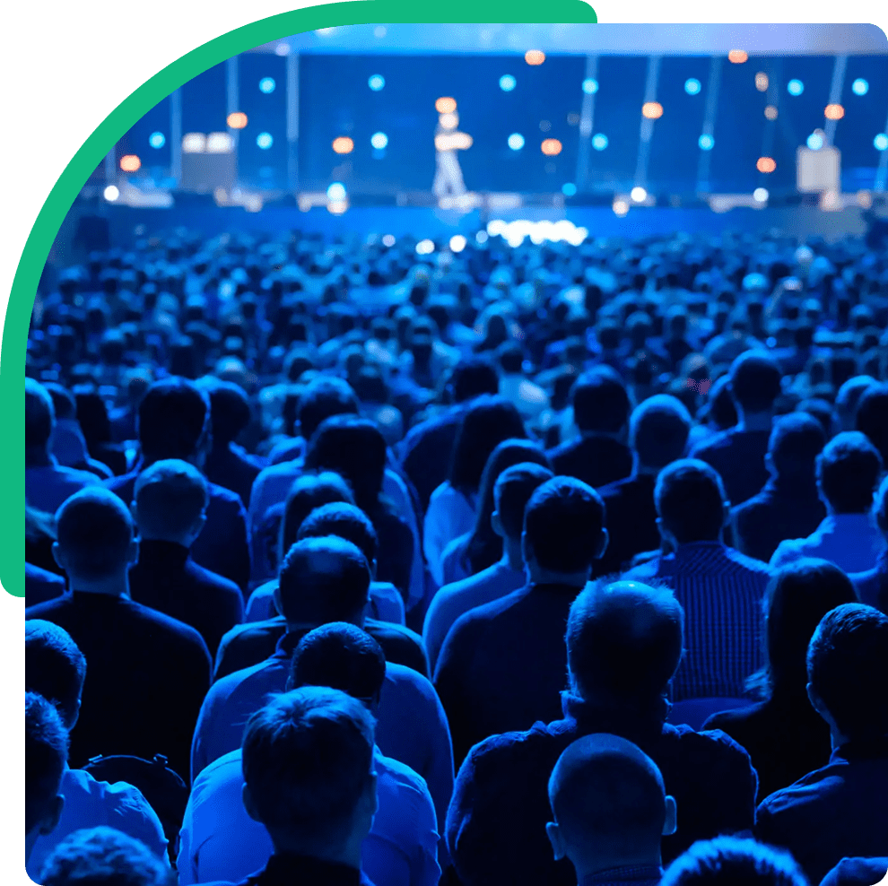 Audience watching a speaker on stage.