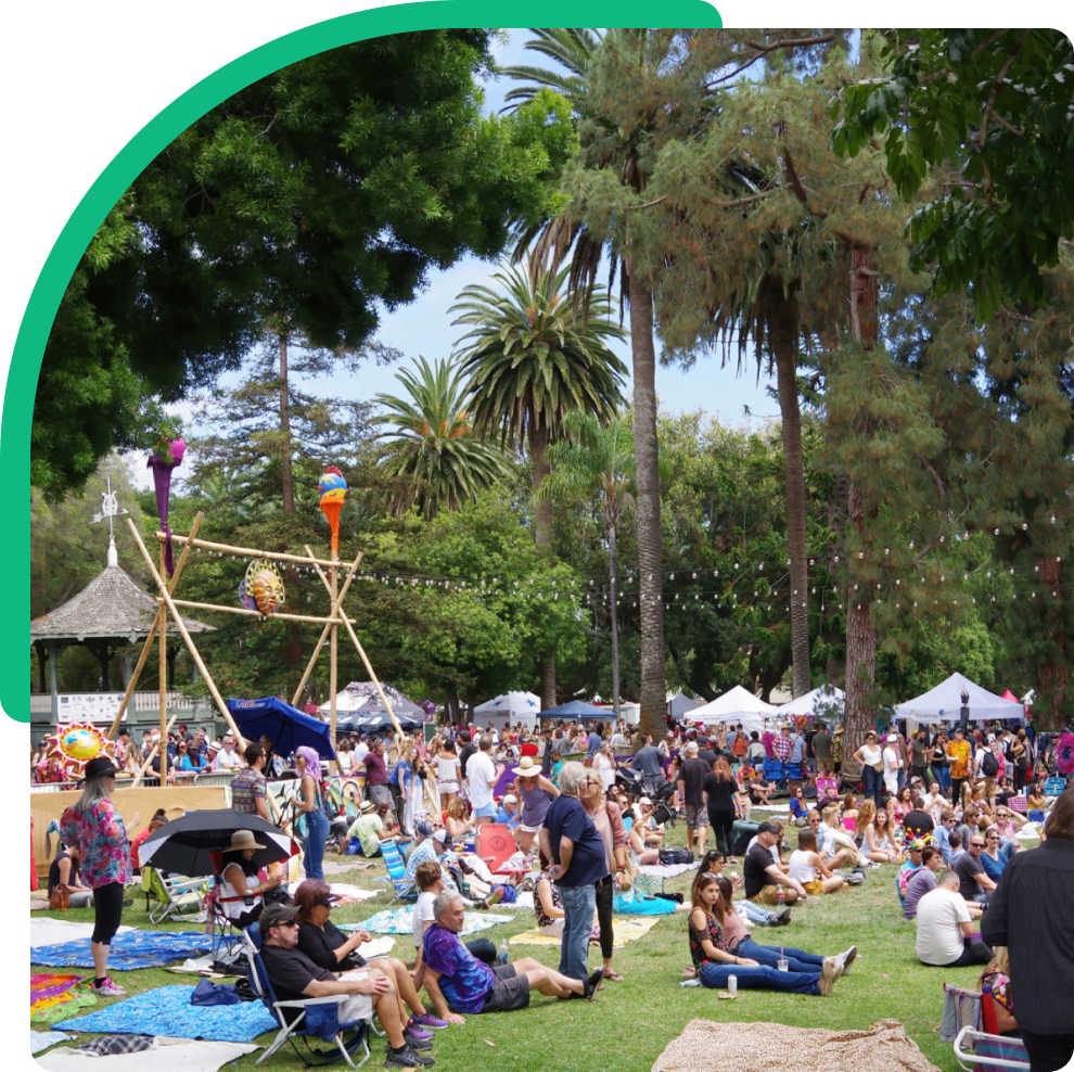 Outdoor festival with people on grassy area.
