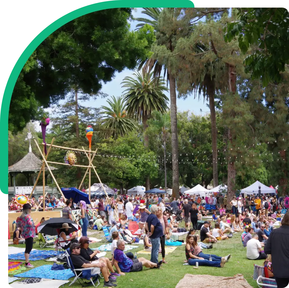 Outdoor festival with people on grassy area